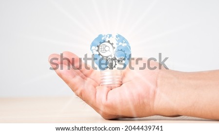 Creative light bulb with world map, growth graph, banking icons. Financial innovation technology develops new products, services that enhance success, profit in global business.