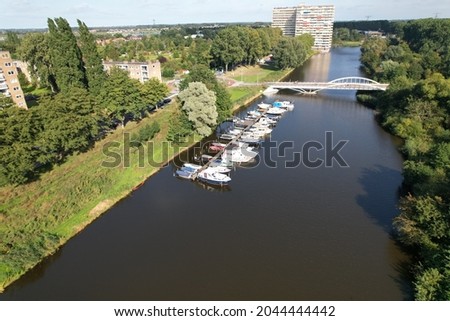 Boating drone shots from Netherlands, small boat docks in residential area.