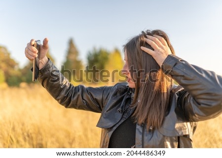 one woman taking a selfie in the field