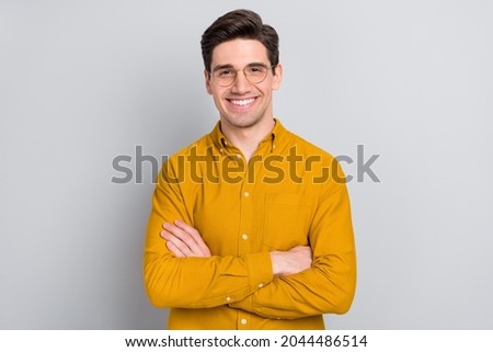 Portrait of attractive cheerful experienced intelligent man folded arms isolated over grey color background