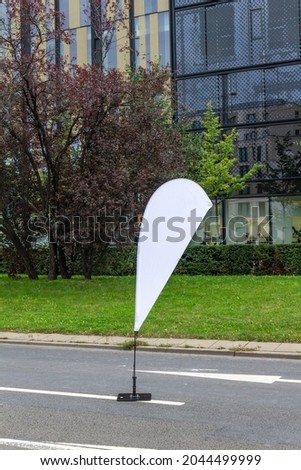 Printed beachflag for outdoor advertising. Royalty-Free Stock Photo #2044499999