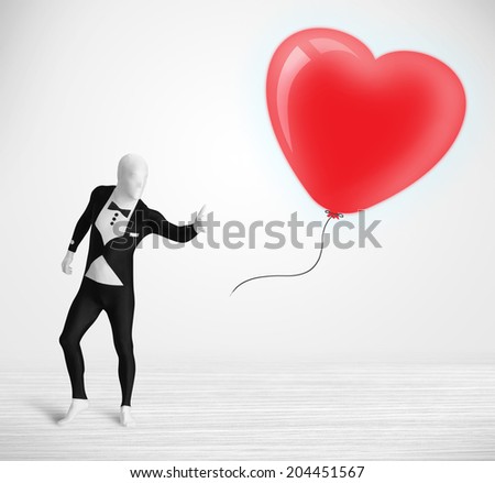 Cute guy in morpsuit body suit looking at a red balloon shaped heart