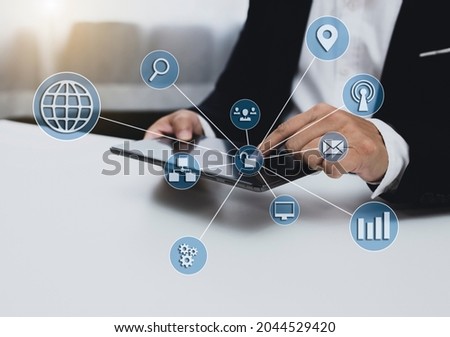 Businessman using digital tablet and Future technology innovation interface icons, Digital transformation network marketing concept, blurred background. 
