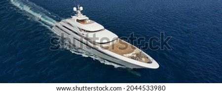 Aerial drone ultra wide panoramic photo of beautiful modern super yacht with wooden deck cruising in high speed deep blue open ocean sea Royalty-Free Stock Photo #2044533980