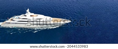 Aerial drone ultra wide panoramic photo of beautiful modern super yacht with wooden deck cruising in high speed deep blue open ocean sea Royalty-Free Stock Photo #2044533983
