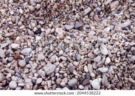 Beautiful soft pebbles on sea shore in Croatia background