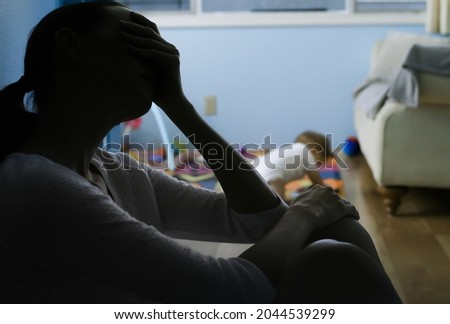 Stressed sad mother taking care of child Royalty-Free Stock Photo #2044539299