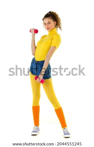 Sporty girl doing sport exercise with red dumbbell