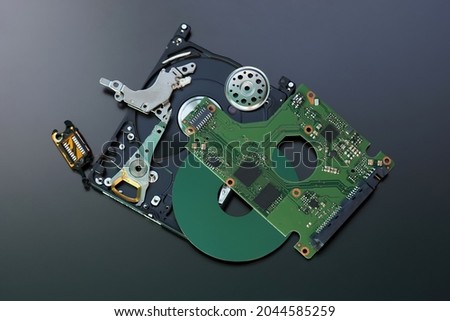 Spare parts hdd drive parts on dark background.  Disassembled 2.5 inch hard disk drive, hdd, top view