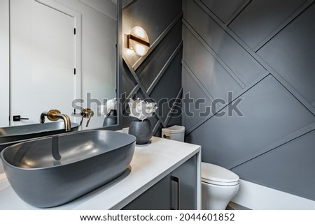 bathroom powder room in black and gold with sink and bronze fixtures
 Royalty-Free Stock Photo #2044601852