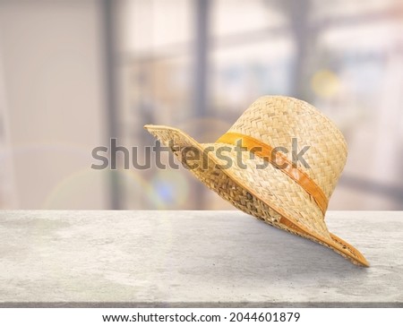 Straw modern beach summer hat on the desk