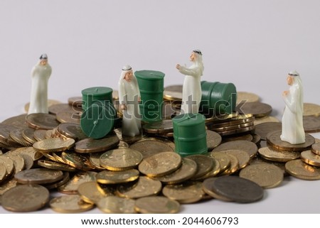 Stack Image of Coins with oils barrel. Crude oil commodity trading in price crisis situation.