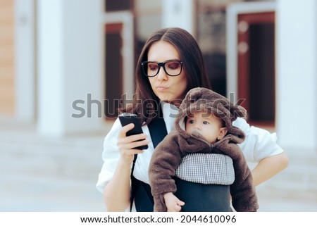 Upset Mother with Newborn in Baby Carrier Reading a Text Message. New mom stressing out for no reason looking every little thing up on the internet 
 Royalty-Free Stock Photo #2044610096