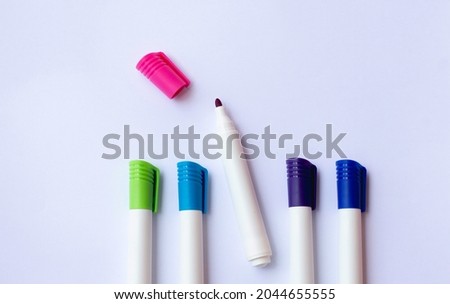 colored markers isolated in white space. educational background concept. free space for texts, learning, campaigns, ads and motivation.