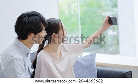 A young couple taking a selfie with a smartphone