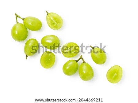 A lot of Shine-Muscat grapes and cut Shine-Muscat grapes on a white background. White grapes.  Japanese grapes. View from above Royalty-Free Stock Photo #2044669211