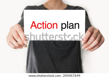 Action plan. Female in black shirt showing or holding a card