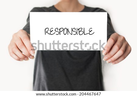 Responsible. Female in black shirt showing or holding a card