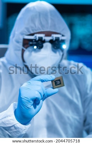 African-American scientist works in a modern scientific laboratory for the research and development of microelectronics and processors. Manufacturing worker uses computer technology and equipment. Royalty-Free Stock Photo #2044705718