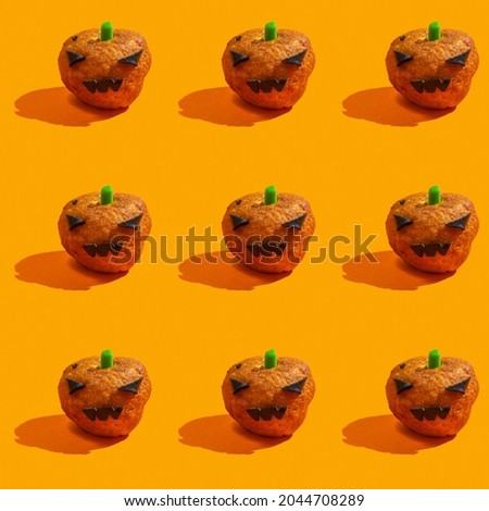 Seamless pattern with fun Halloween food. Halloween pumpkin donut on orange background.