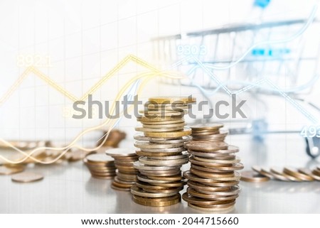 grocery cart and coins close-up on a white background