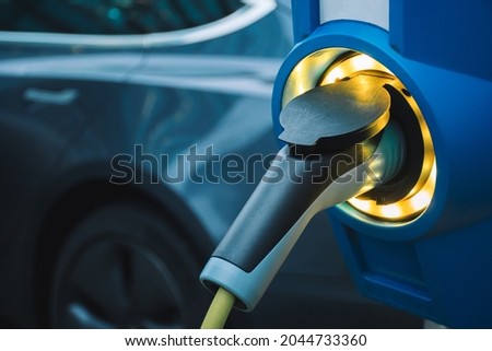 Electric vehicle charging station, electrical car charging unit, recharging point, charging point, charge point, electronic charging station ECS with car, no brand Royalty-Free Stock Photo #2044733360