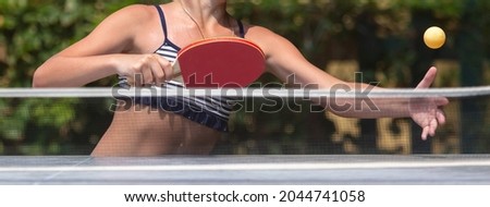 The girl plays table tennis. Sport