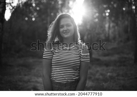 Portrait of a young girl in the woods at sunset. Walking in the woods in his spare time