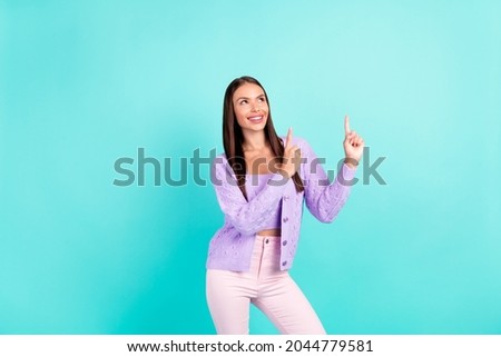 Photo of dreamy curious lady direct fingers up empty space wear violet cardigan isolated teal color background