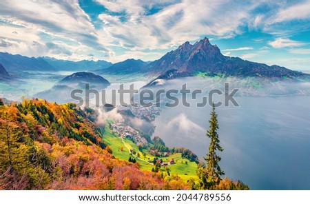Captivating morning view of outskirts of Stansstad town, Switzerland, Europe. Impressive autumn scene of  Lucerne lake. Majestic landscape of Swiss Alps. Traveling concept background.