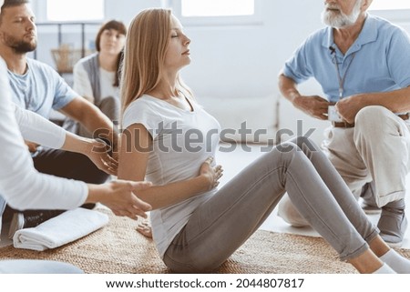 Young woman learning how to breath with diaphgragm during therapy session Royalty-Free Stock Photo #2044807817