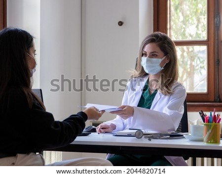 Female Doctor Discussing In Her Room With Her Patient