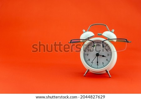 Concept Education or business Alarm clock and teacher glasses Business objects isolated on colorful background Back to school concept
