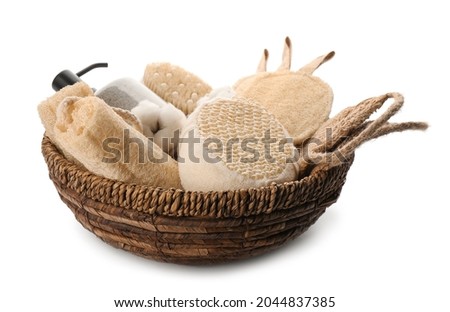 Set of toiletries with natural loofah sponges in wicker basket isolated on white Royalty-Free Stock Photo #2044837385
