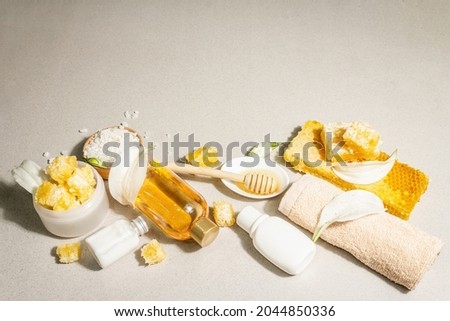 Spa concept. Self care with honey, sea salt, and cream. Natural organic cosmetics, homemade products, alternative lifestyle. Light stone background, copy space