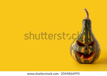 Halloween green pumpkin on yellow background. Copy space