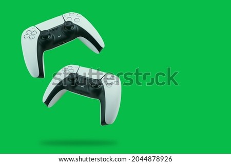 Next Generation Controllers falling on green background. Royalty-Free Stock Photo #2044878926