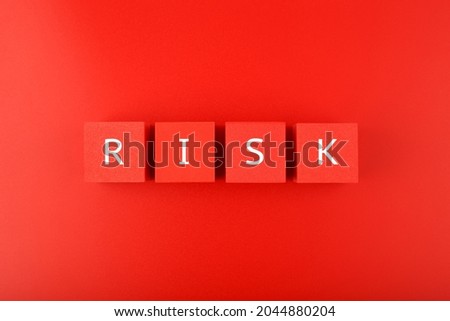 Risk single word written on red cubes against red background. Concept of risk and danger in business, social life, health, life style decisions or strategy Royalty-Free Stock Photo #2044880204