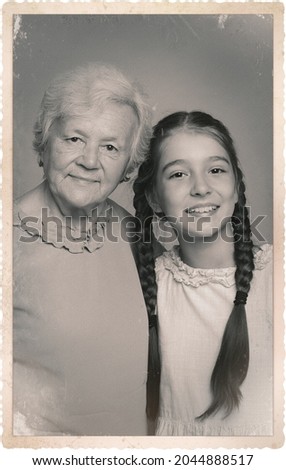 Old picture of cute girl with her grandmother. Portrait for family tree