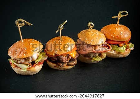mini burgers on the black background
