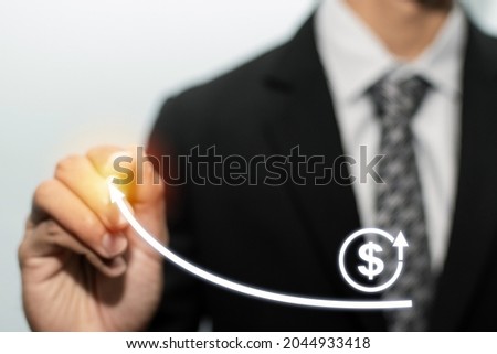 businessman investor hand pointing with pen on virtual graphic US dollar icon on white background, stock market, investment, digital technology, trading statistics and business strategy concept