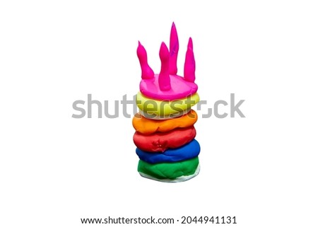 Multicolored cake shape are plasticine (clay) placed on a white background
