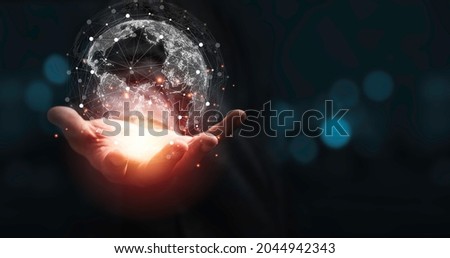 Hand holding virtual world with copy space and blue bokeh background for technology information and transformation concept.