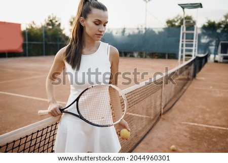 Young woman tennis player with racket