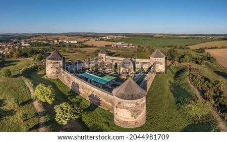 Aerial view of Bzovik, Bozok fortified monastery church in southern Slovakia with four round cannon towers and bridge over the dry moat
