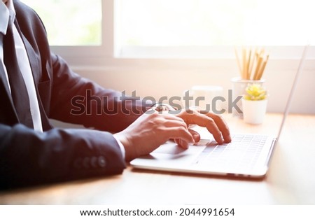 Business man using and typing keyboard of laptop computer on office desk with communicates on internet technology. Workplace, professional busy working on new job project idea.