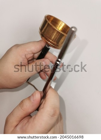 Defocused and blur image of someone demonstrated prayer bell. It's one of the famous ritual tools and usually being used for meditation and healing.