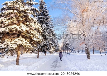 beautiful mature women walk in the winter park
