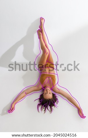 Lines around body before loosing weight. Young beautiful woman with perfect slim fir body in inner wear isolated over white background. Concept of healthy eating, dieting, loosing weight, fitness, ad