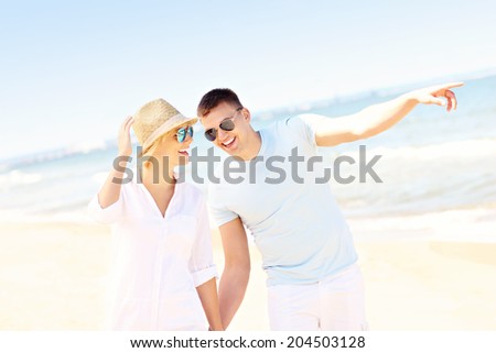 A picture of a romantic happy couple walking along the beach in Poland
